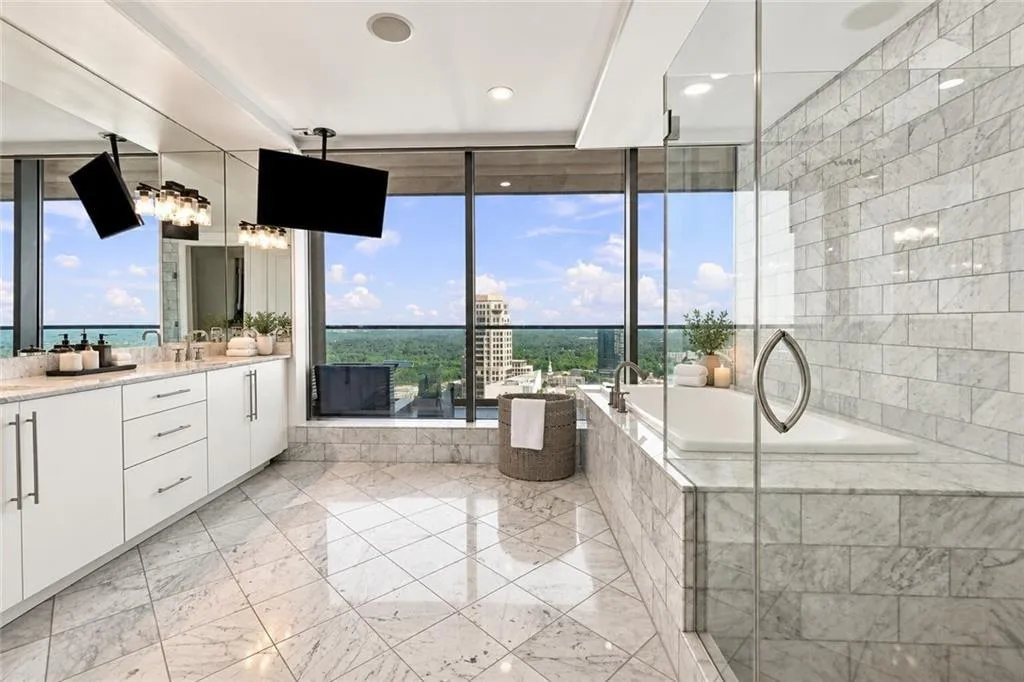 Luxurious oversized master bath suite with double sinks, separate jacuzzi tub and frameless glass shower