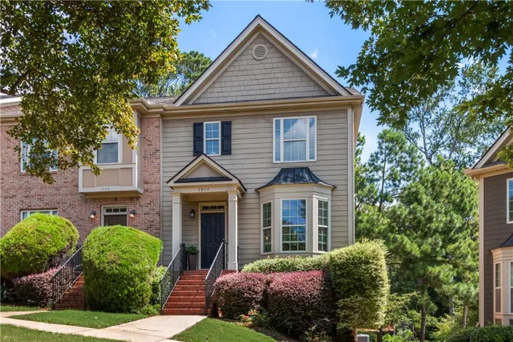 Exterior featuring a covered entry, bay window, and brick stairs