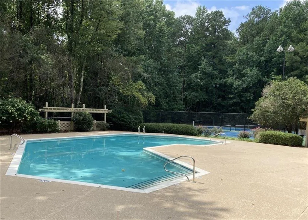 Community pool with a patio area Community pool with a patio area