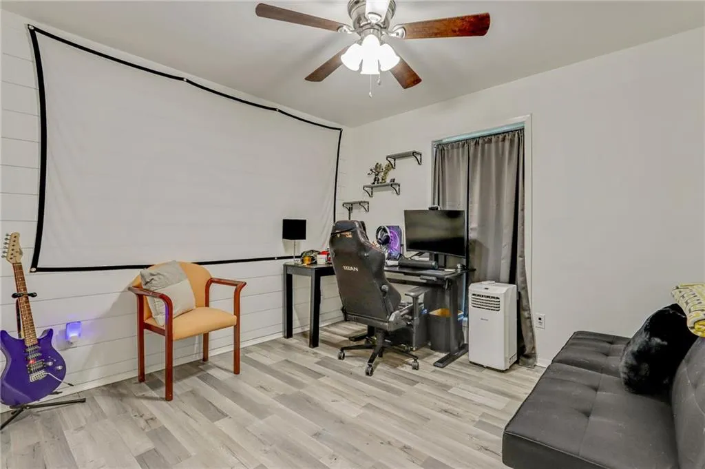 Office featuring wood finished floors and a ceiling fan Office featuring wood finished floors and a ceiling fan
