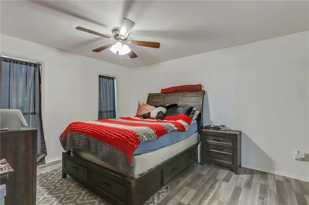 Bedroom featuring wood finished floors and ceiling fan Bedroom featuring wood finished floors and ceiling fan