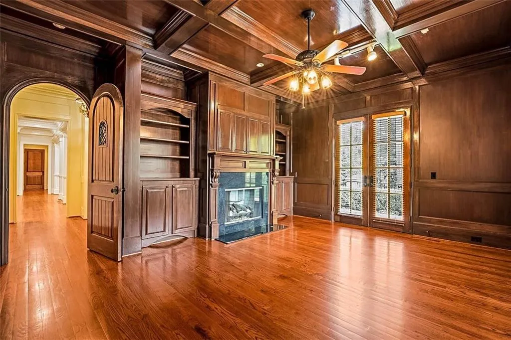 wood paneled office  coffered ceiling, french doors