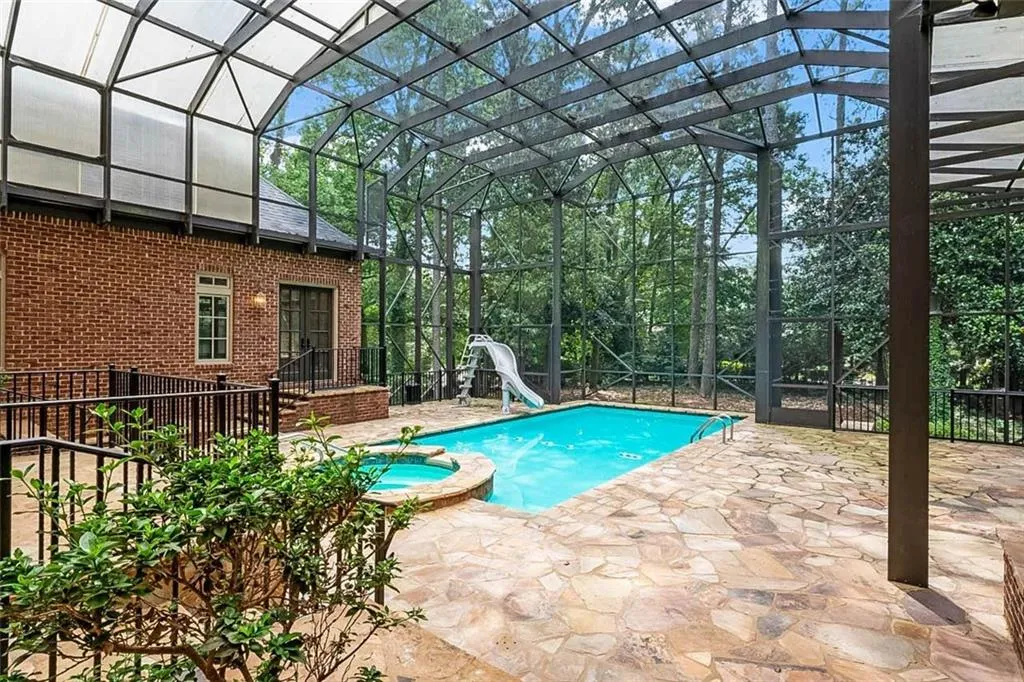 View of pool featuring a patio area, a lanai, and a water slide