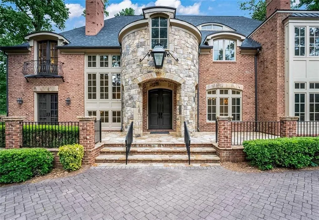 View of front facade with a balcony and french doors
