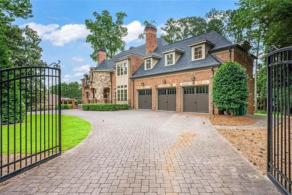 View of front of property featuring a front yard and a garage
