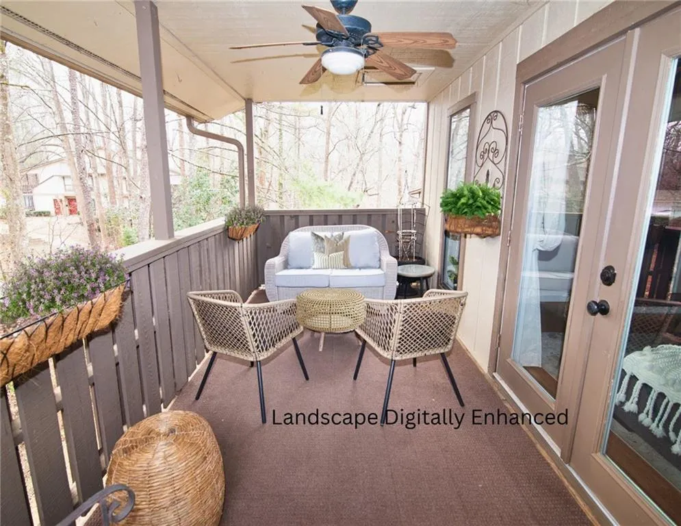 Sunroom featuring french doors, a ceiling fan, and a balcony