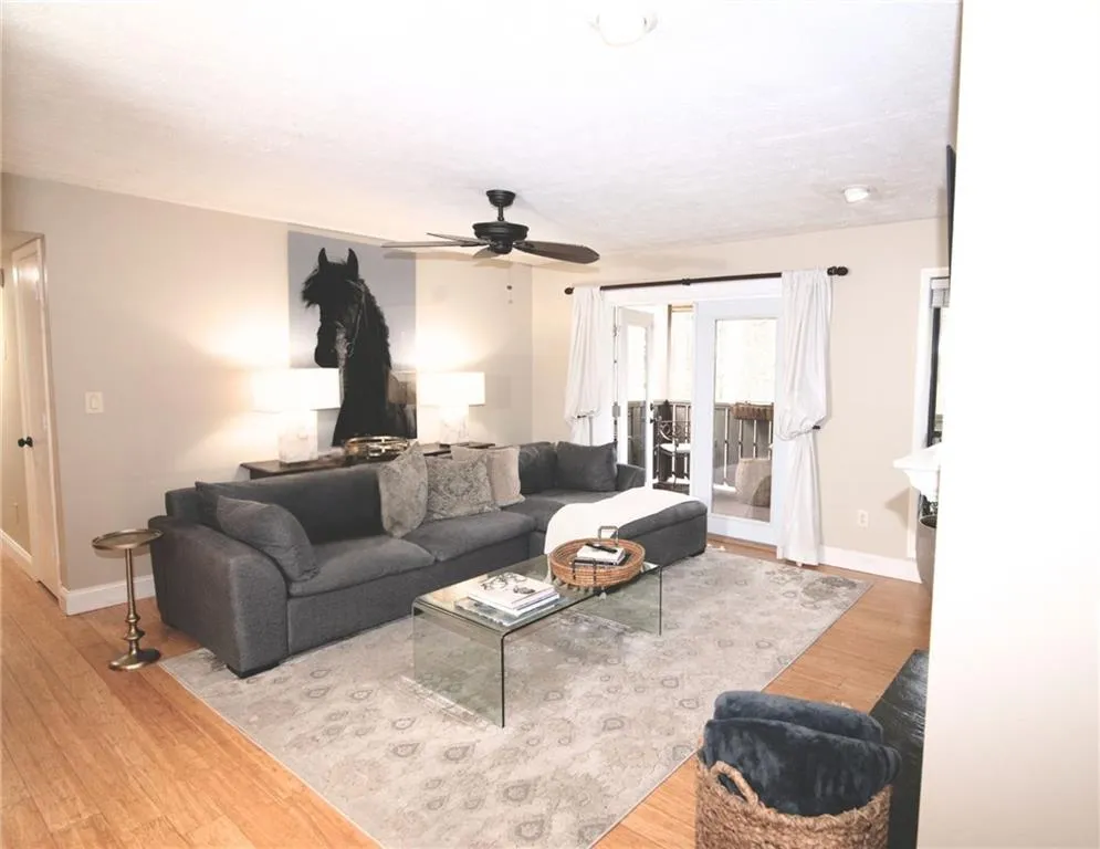 Living room featuring wood finished floors and ceiling fan