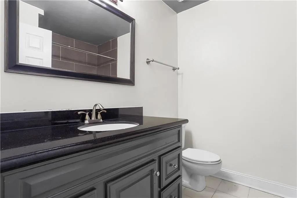 Full bathroom featuring vanity and light tile patterned flooring