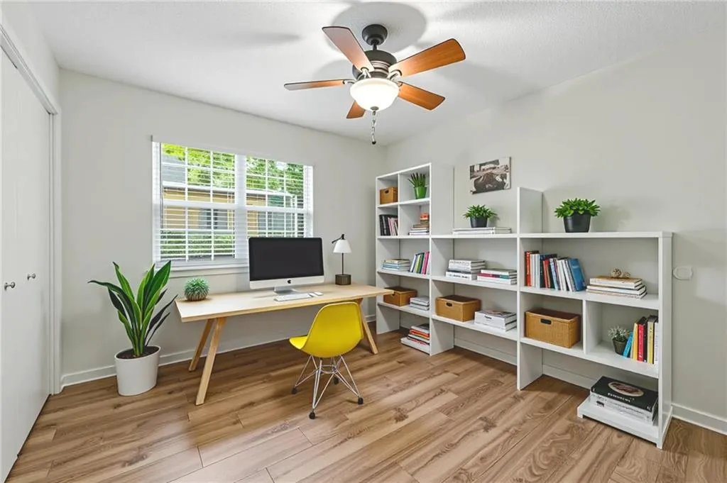 Office space with wood finished floors and ceiling fan
