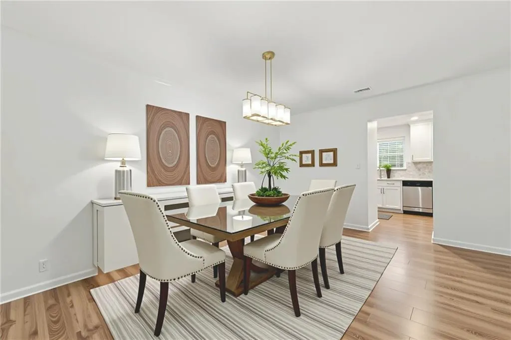 Dining space with light wood-style flooring and baseboards