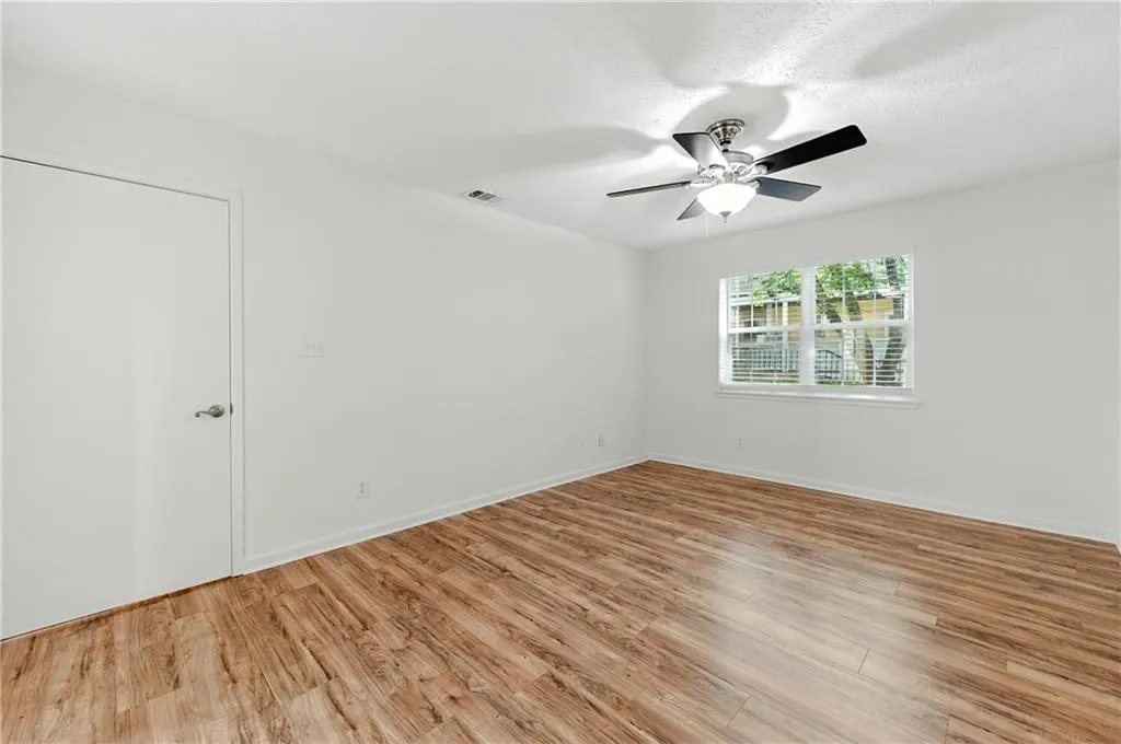 Unfurnished room with light wood-type flooring and baseboards