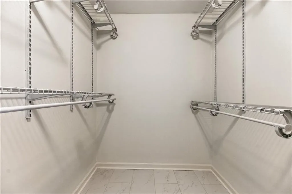Spacious closet with light marble finish flooring