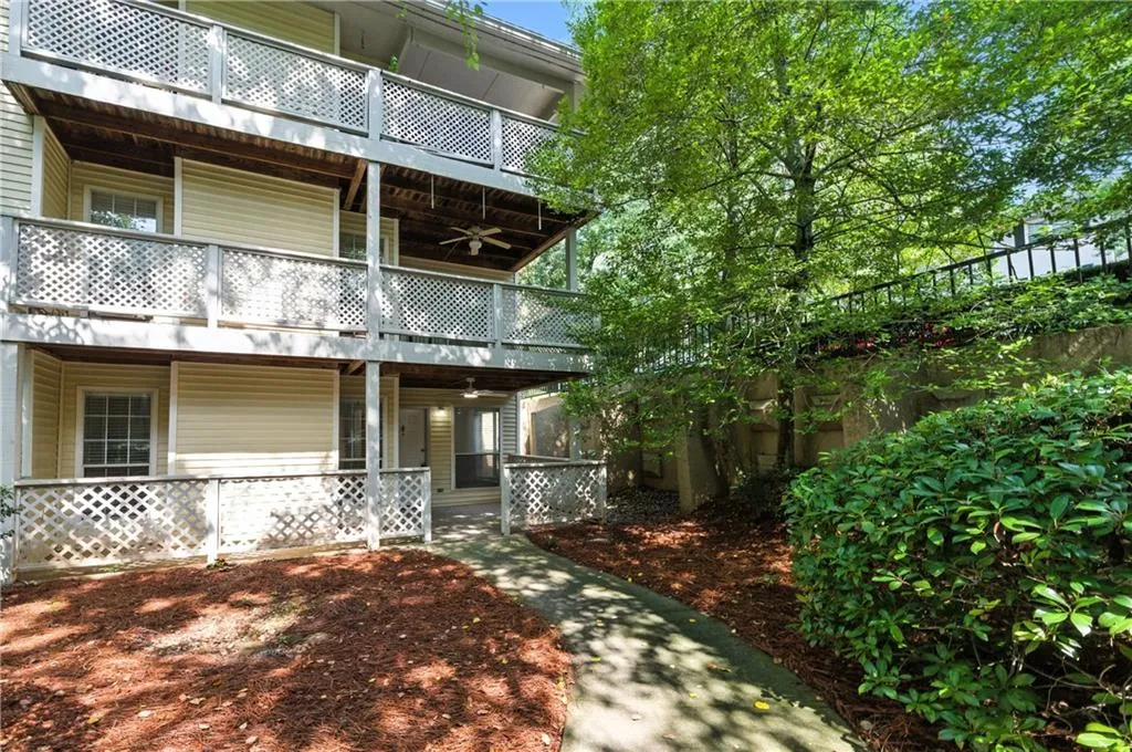 View of front of house with a balcony, a ceiling fan, and covered porch