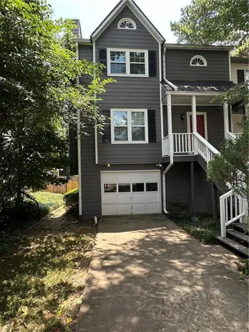 Contemporary gray siding exterior with white window trim and black shutters