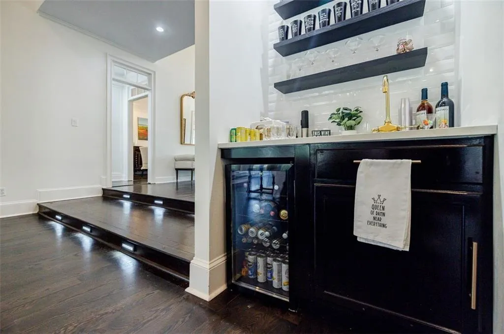 Bar featuring a bar, baseboards, and wood finished floors