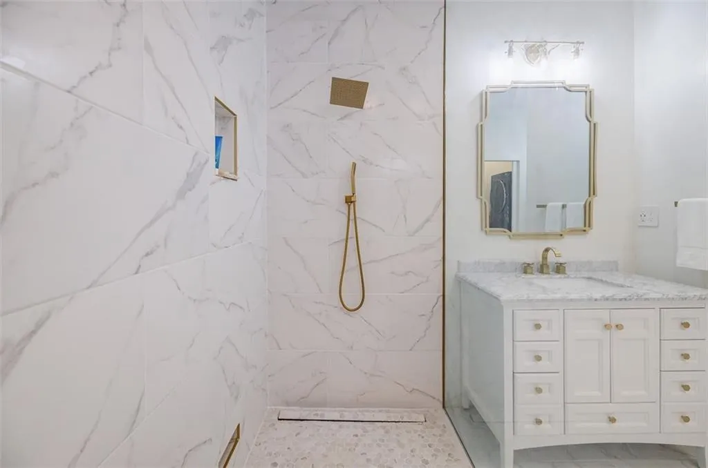 Full bathroom with marble finish floor, vanity, and a marble finish shower