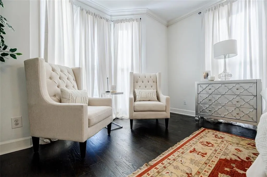 Sitting room featuring baseboards, ornamental molding, and wood finished floors