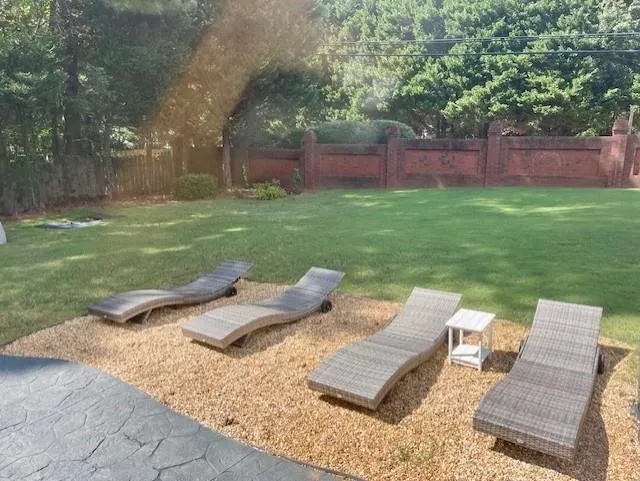 View of yard featuring fence