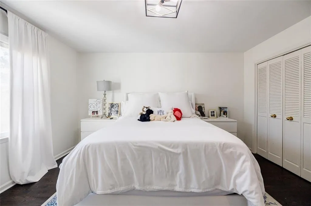 Bedroom with baseboards, a closet, and dark wood finished floors