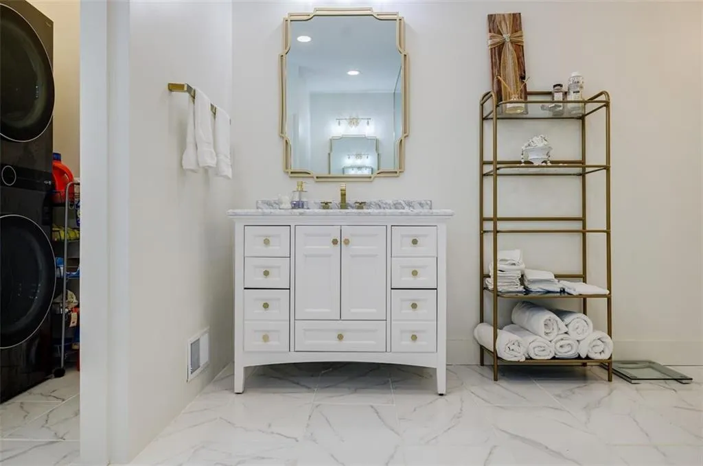 Bathroom with marble finish floor, visible vents, recessed lighting, and vanity