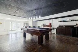Recreation room with pool table and wood finished floors