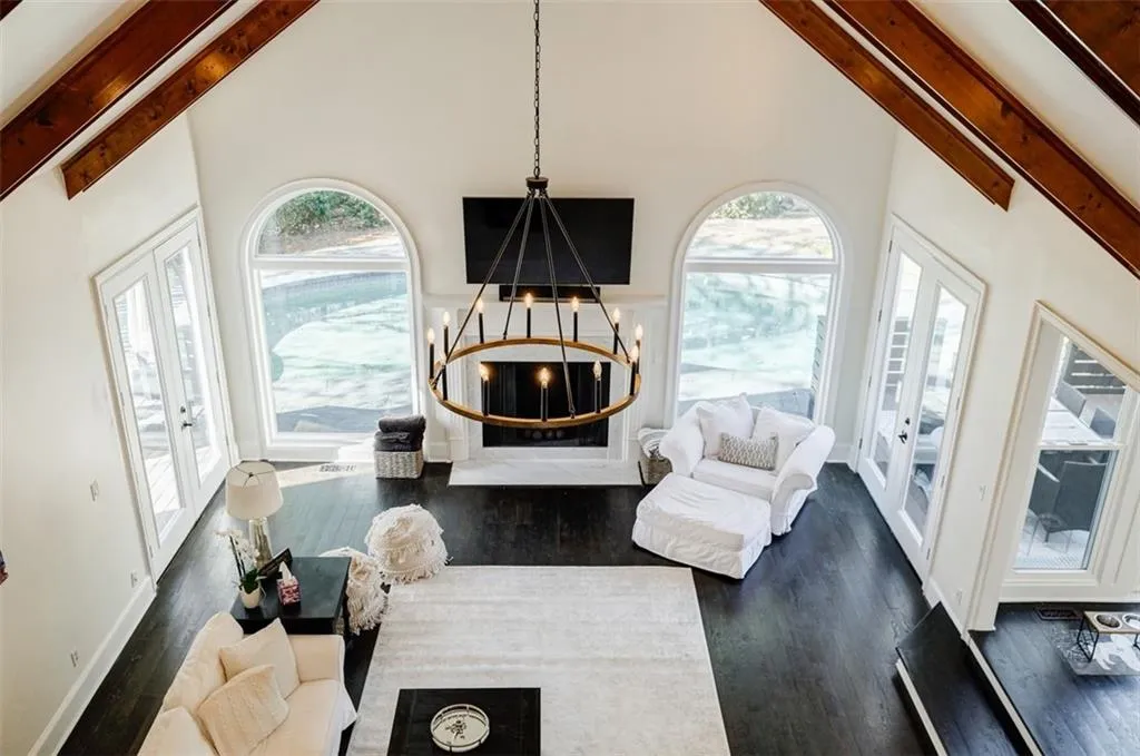 Living room featuring french doors, high vaulted ceiling, beamed ceiling, and dark wood finished floors