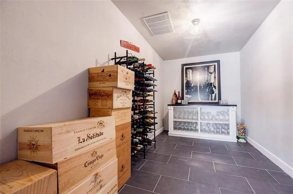 Wine area featuring baseboards, lofted ceiling, and visible vents