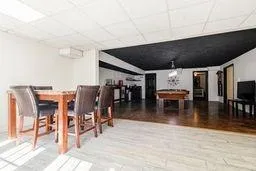 Dining room featuring wood finished floors, pool table, and a drop ceiling
