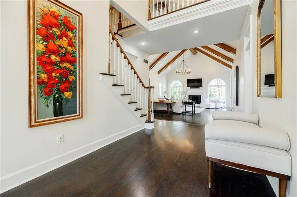 Living room with stairway, high vaulted ceiling, baseboards, dark wood finished floors, and a fireplace