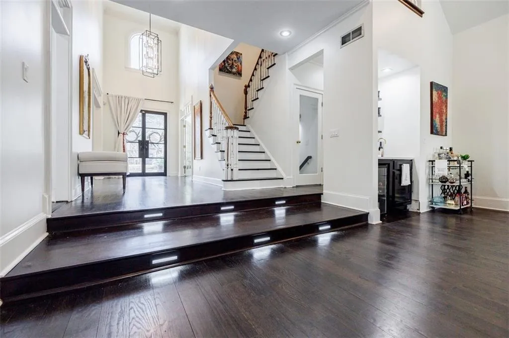 Foyer featuring french doors, stairway, baseboards, visible vents, and hardwood / wood-style floors