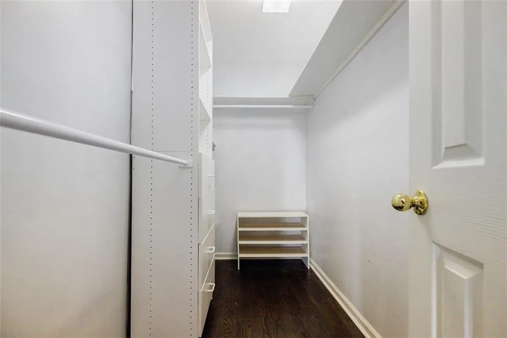 Walk in closet featuring wood finished floors