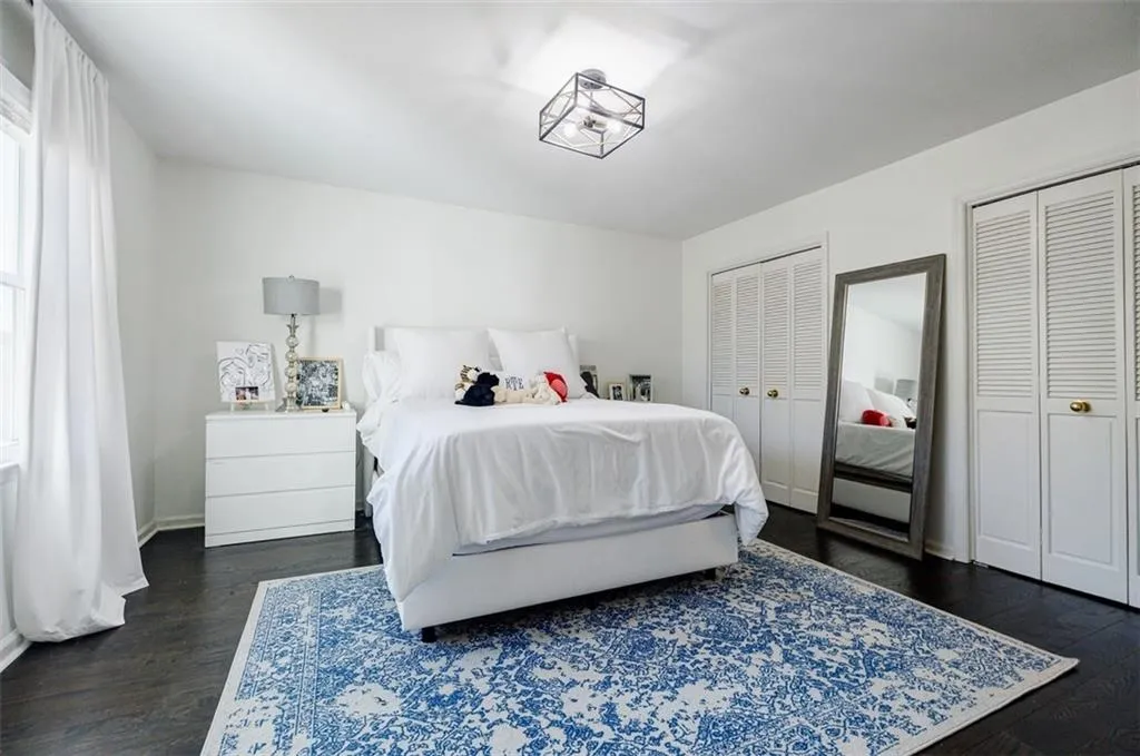 Bedroom featuring two closets and dark wood finished floors