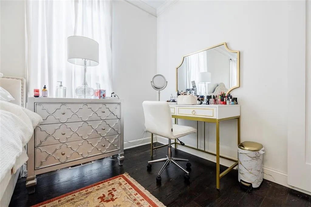 Home office with baseboards, dark wood-style flooring, visible vents, and crown molding