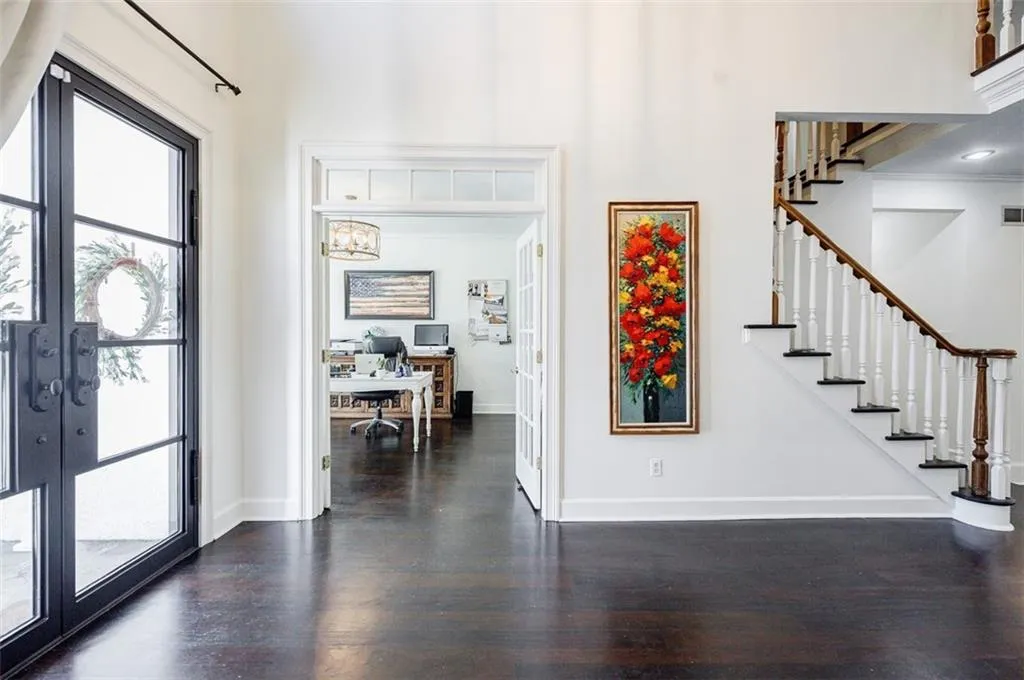 Entrance foyer with baseboards, stairway, wood finished floors, and french doors