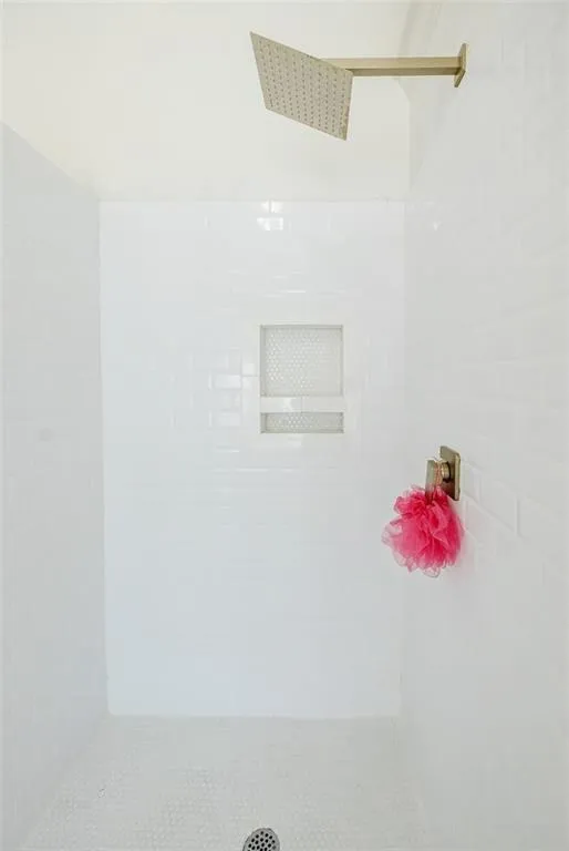 Full bath featuring tiled shower