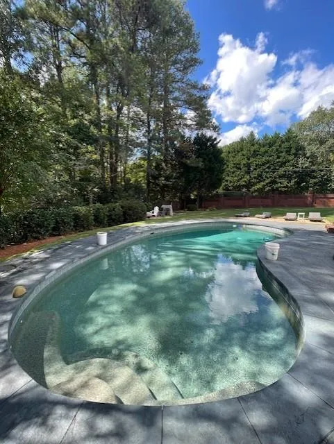 View of swimming pool with fence and a fenced in pool