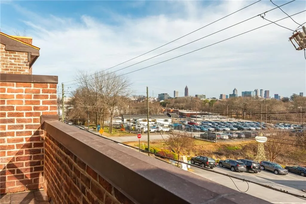 Upper level primary bedroom with private balcony and views of the Atlanta skyline