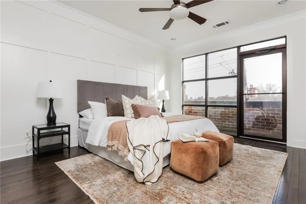 Upper level primary bedroom with private balcony and views of the Atlanta skyline