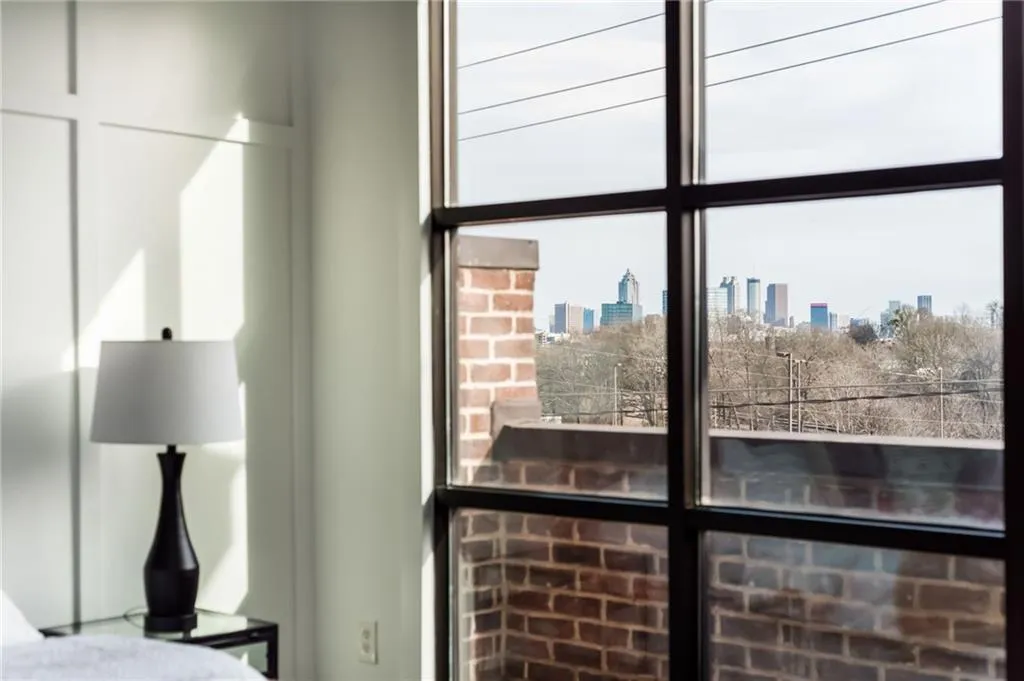 Upper level primary bedroom with private balcony and views of the Atlanta skyline