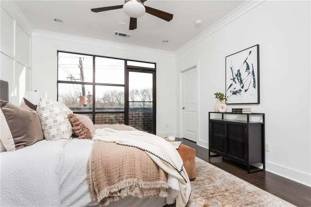 Upper level primary bedroom with private balcony and views of the Atlanta skyline