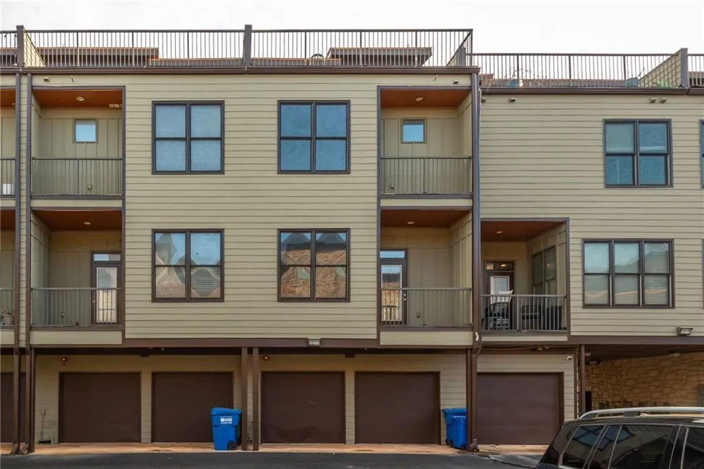 Rear of property with gated, secure parking and 2-car garage