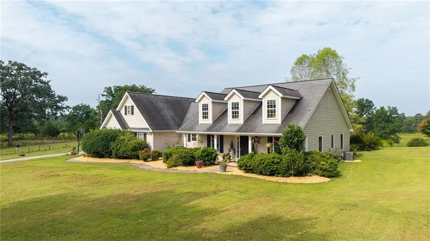 Ranch-style exterior with dormer windows, a covered front entry, and a pitched roof