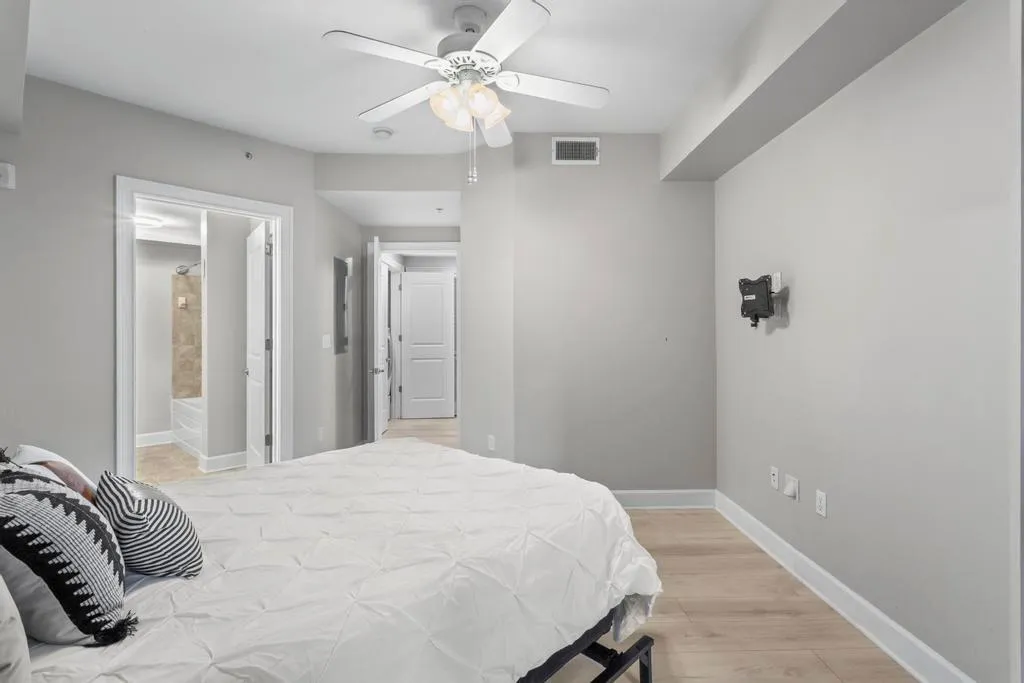 Bedroom #1 featuring light hardwood / wood-style floors, ceiling fan, and ensuite bathroom