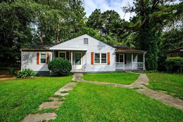 Front exterior with light-colored siding and an accent trim