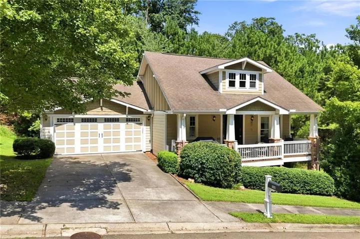 Craftsman-style exterior with a covered front porch, dormer window, and stone accents