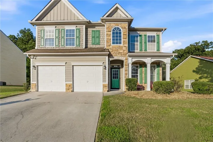 Stone and siding exterior with a two-car garage
