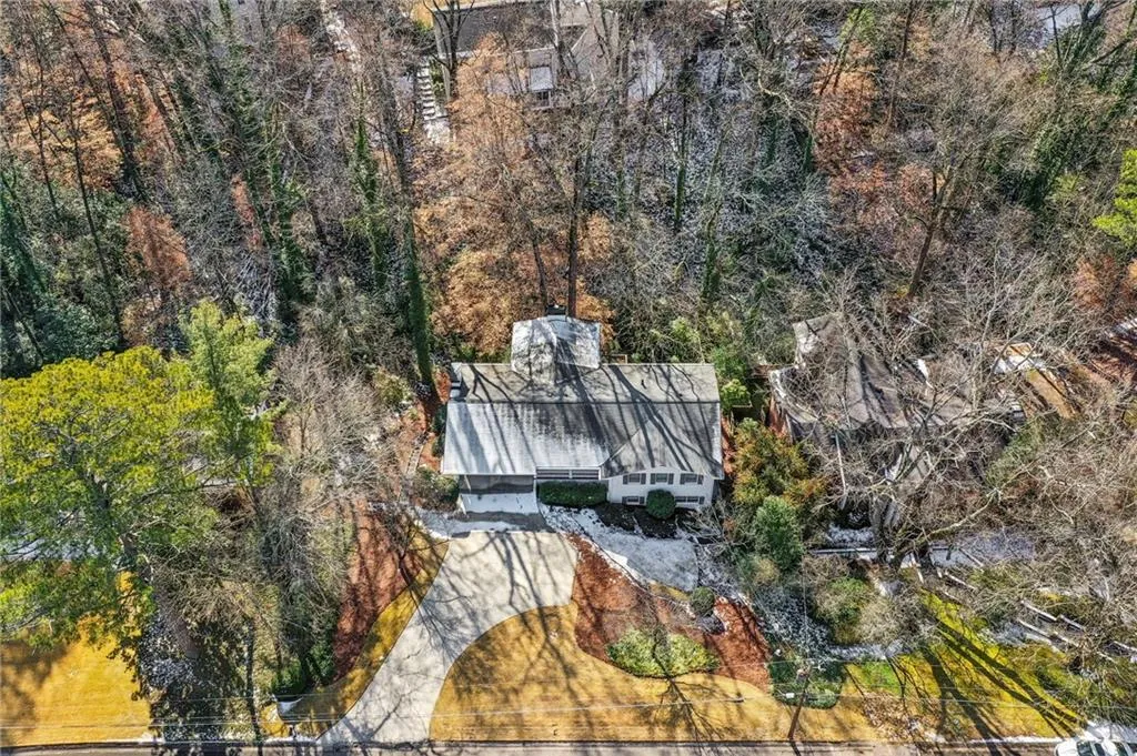 Roof is only 3 years old. Aerial view shows how privacy and beauty of this wooded lot. Snow on roof is rare and melted by now!