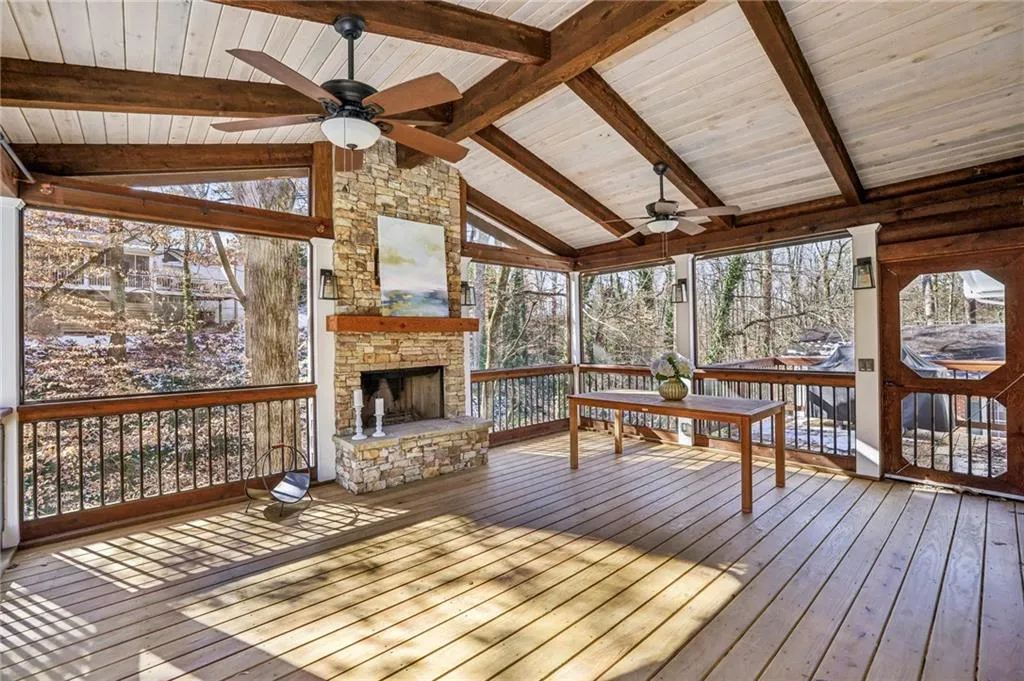 First floor screen porch with fireplace and TV mount.