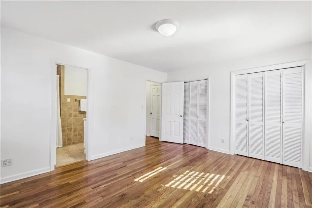 Double closets and view to attached bathroom