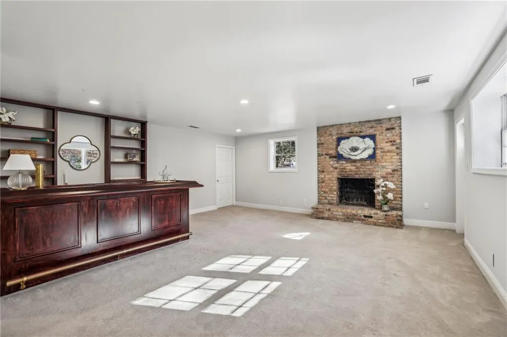 Basement has beautiful built in bar, a third fireplace and exterior door to backyard.